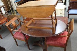 An antique mahogany oval table and a pair of inlaid mahogany armchairs