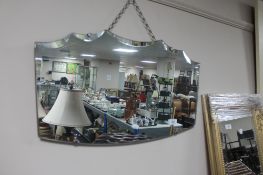 An early 20th century frameless mirror