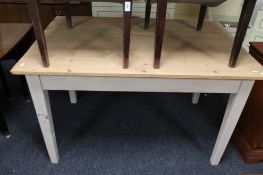 A pine farmhouse table with painted legs