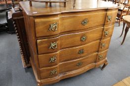 A 19th century oak four drawer serpentine fronted chest.