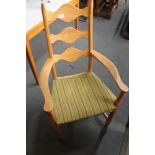 A light oak armchair with green striped fabric.