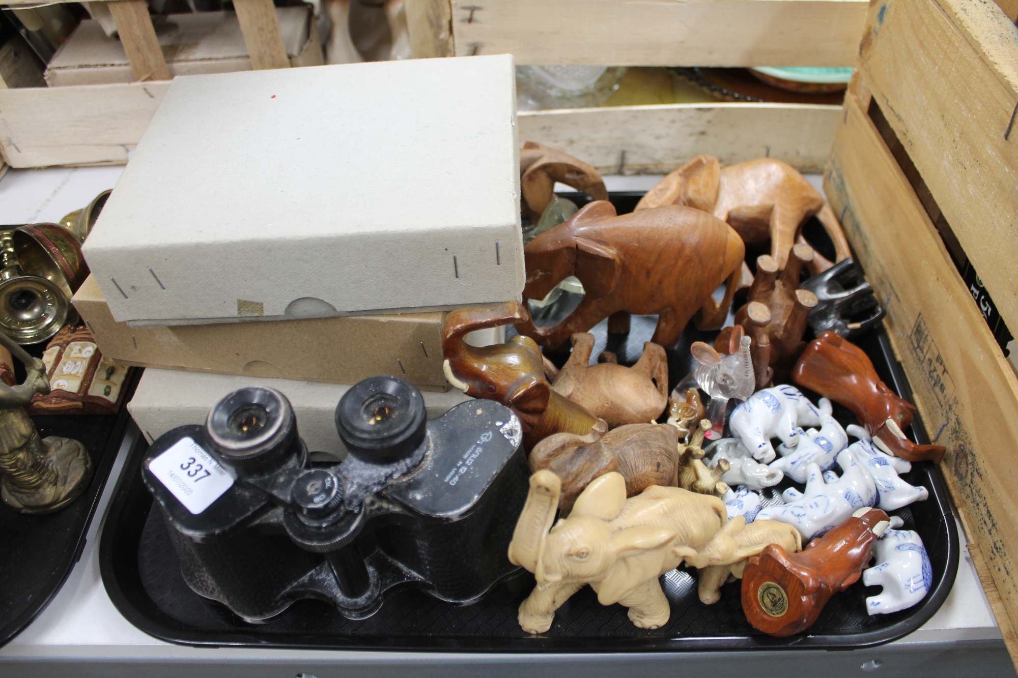 A tray of binoculars, elephant ornaments, china figures,