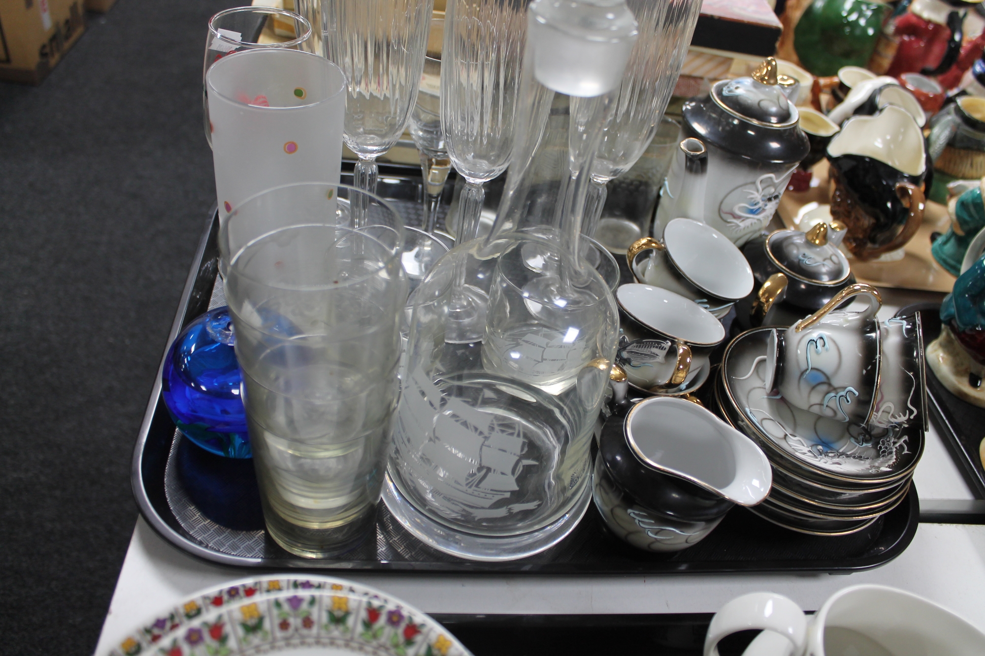 A tray of glass, champagne flutes, decanter,