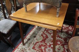 A teak pull out mid century dining table