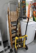 Two folding step ladders together with a brass floor lamp and sack barrow