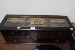 A glazed mahogany four drawer chest bearing 'Ringtons Tea Merchant' advertising