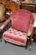 A reproduction armchair in button pink dralon.