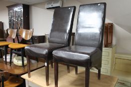 A pair of brown leather dining chairs