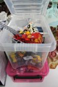 A crate of die cast vehicles and a box of lego