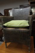 A Wicker conservatory chair with green cushion