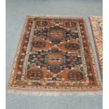 An Afghan Bokhara rug on rust ground,