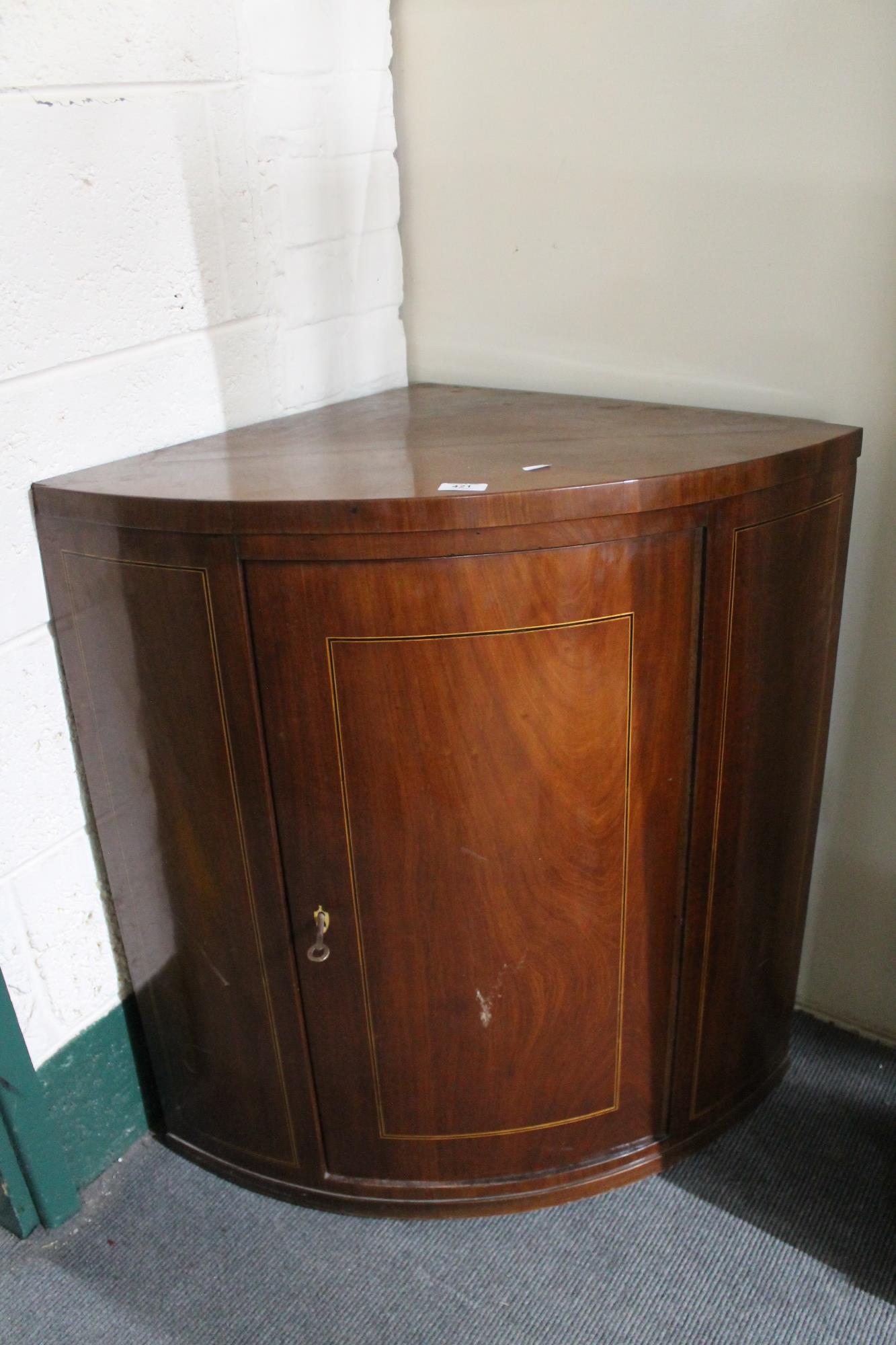 An inlaid mahogany corner cabinet