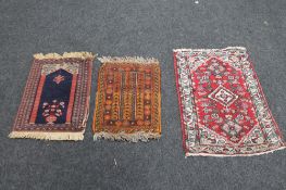 A small Persian prayer mat and two other similar rugs (3)