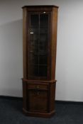 A walnut reproduction corner cabinet