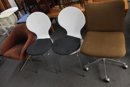 A mid century swivel office chair, pair white chairs and one further low chair.