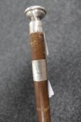 A swagger stick with silver mounts