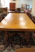 A good quality Edwardian oak dining room table, with pedestal under stretcher,