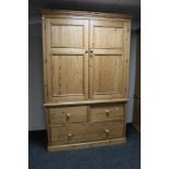 An antique style pine double door wardrobe with three drawer chest to base, height 222 cm,