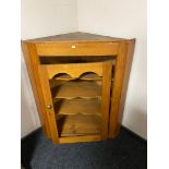 A nineteenth century pine corner cabinet