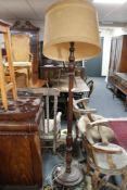 An antique oak standard lamp with shade,