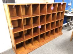 A wooden haberdashery shop display cabinet with 32 compartments, height 132 cm, depth 51.