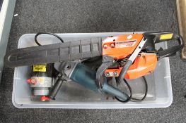A petrol chainsaw together with a Bosch grinder etc