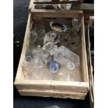 A crate of glass decanters,