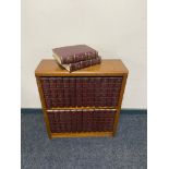 A small wooden bookshelf with encyclopedia Britannica