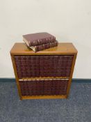 A small wooden bookshelf with encyclopedia Britannica
