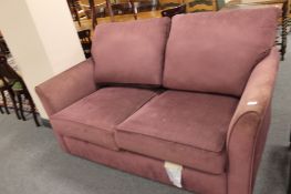 A purple two seater bed settee