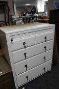 A painted white chest of five drawers