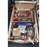 A crate of stainless steel cutlery