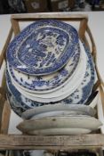A crate of antique and later blue and white meat plates,