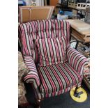 A contemporary striped buttoned armchair with cushion