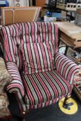 A contemporary striped buttoned armchair with cushion