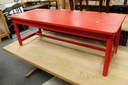 A painted red coffee table together with a further teak coffee table