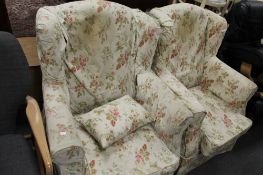 A pair of Edwardian armchairs with floral coverings