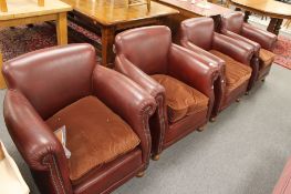 A set of four Burgundy studded leather armchairs, each 83 cm wide.