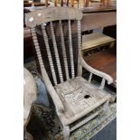 A nineteenth century wooden armchair with bobbin turns