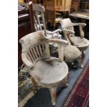 A pair of antique wooden armchairs together with a wooden stool