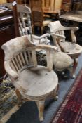 A pair of antique wooden armchairs together with a wooden stool