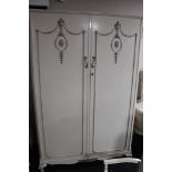 A three piece cream and gilt bedroom suite - double wardrobe, dressing table with stool,