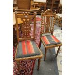 A pair of continental carved oak dining chairs