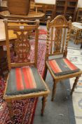 A pair of continental carved oak dining chairs