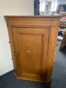 A Victorian pine corner cabinet