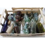 A tray of antique and later glass bottles