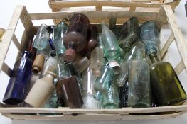 A tray of antique and later glass bottles