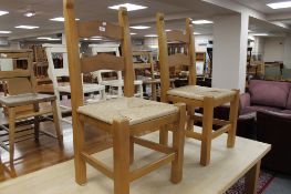 A pair of pine farmhouse ladder backed chairs