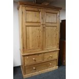 An antique style pine double door wardrobe with three drawer chest to base, height 213 cm,