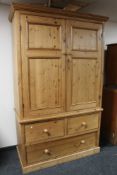 An antique style pine double door wardrobe with three drawer chest to base, height 213 cm,